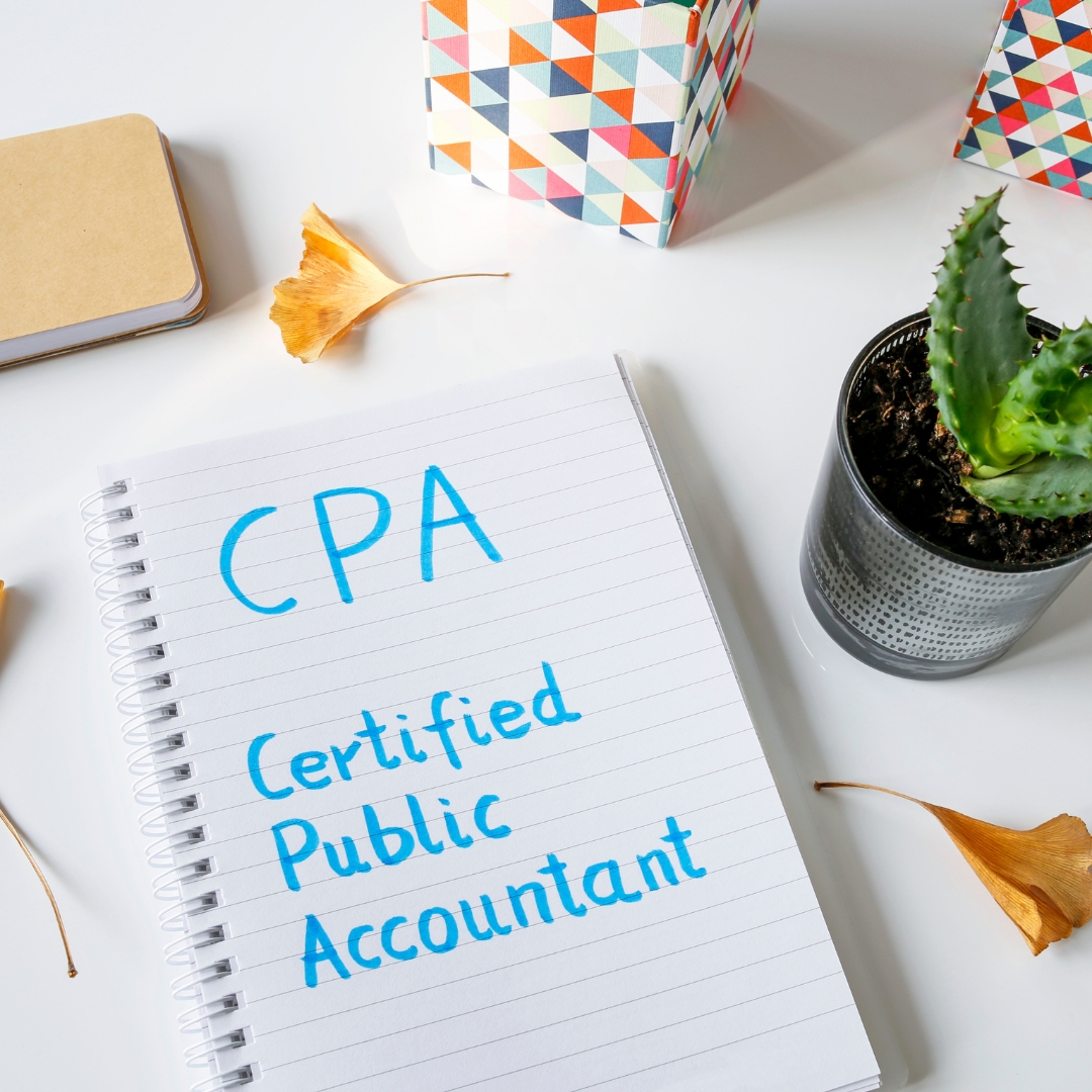 certified public accountant writing in a notebook